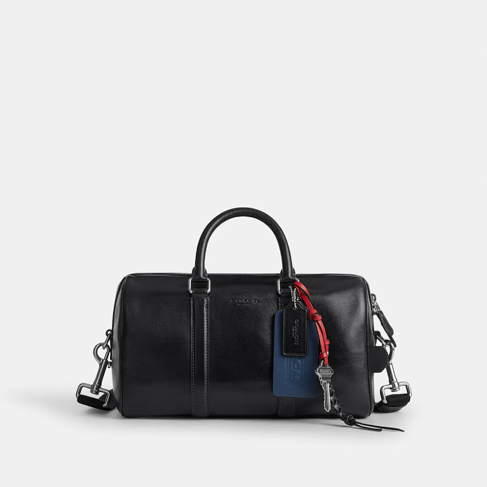 【COACH】蔻馳官方直營 VENTURER 27 掛件裝飾行李袋 旅行袋 斜背包-SV/黑色(CDY54)